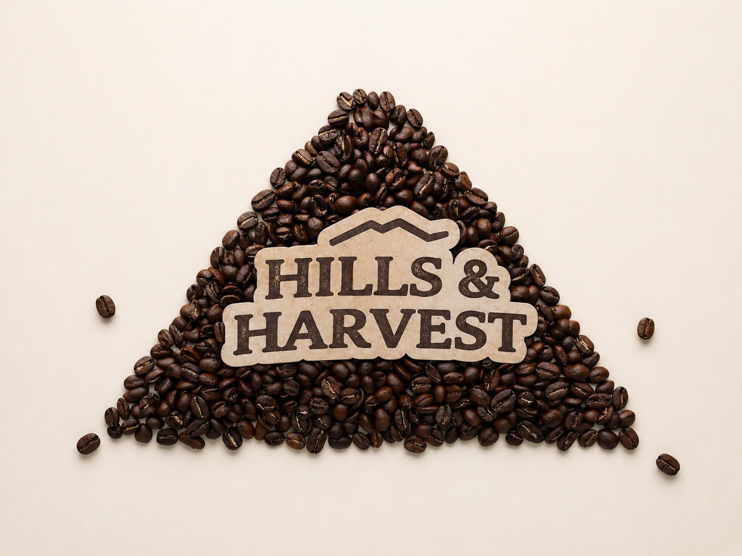 Hills & Harvest logo over a bed of roasted coffee beans — premium Guatemala single origin coffee
